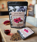 Loose leaf herbal tea package with hibiscus flowers, cinnamon, rose hips, and orange peel on a wooden surface