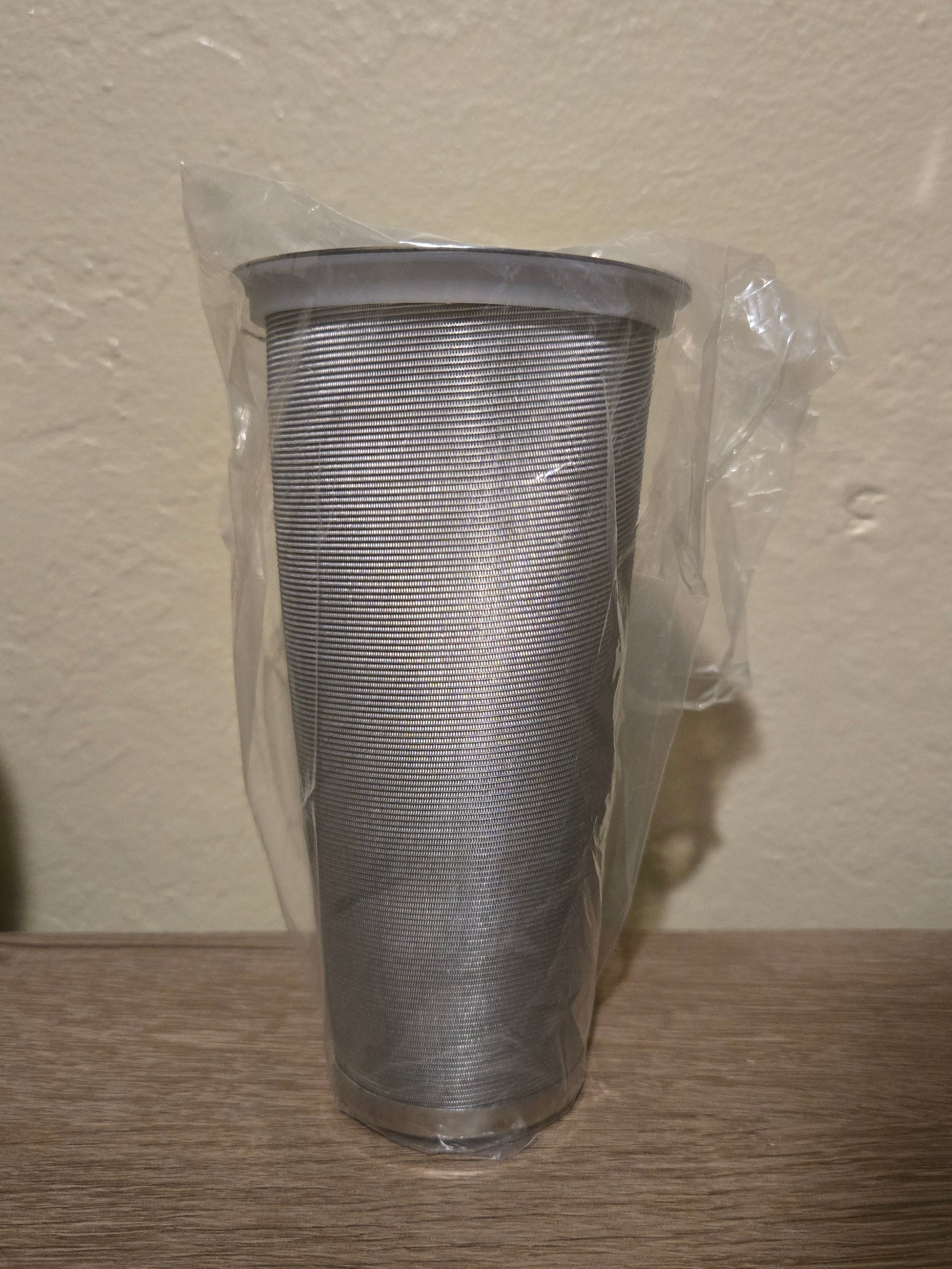 Metal cold brew filter on a wooden surface